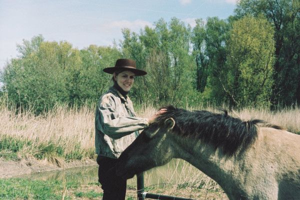 The photo of a woman stroking a horse.
