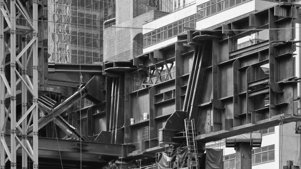 Exposed steelwork of a skyscraper under construction, forming an abstract composition.