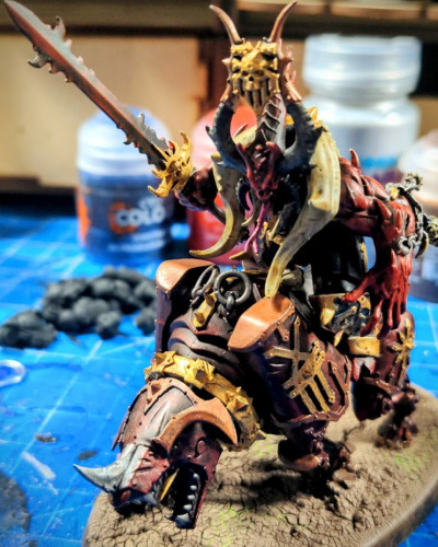 Khorne Daemon Skullmaster riding on a Juggernaut miniature by Games Workshop.